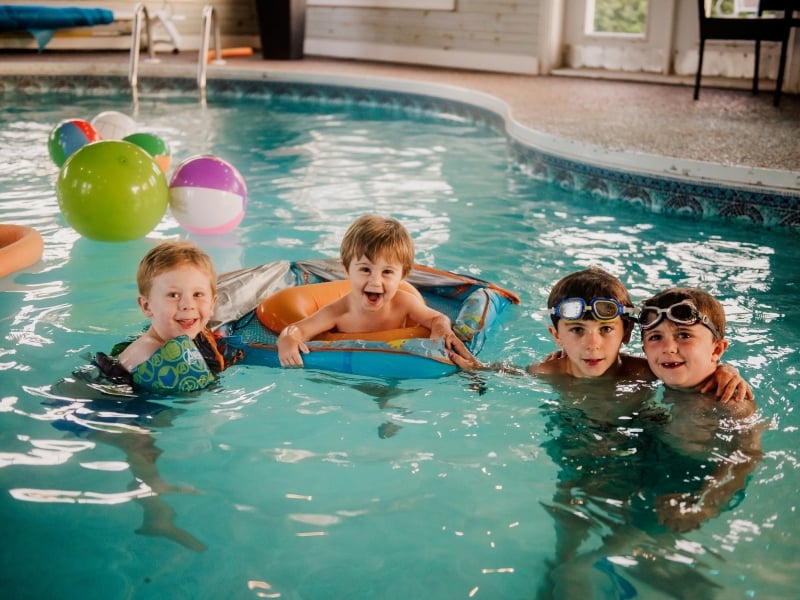 Four children play in indoor pool